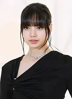 Lisa (BLACKPINK) wearing jewel-toned statement dressing with crisp contrast and sparkle, showcasing neon fuchsia, electric blue, optic white, chrome, and jet black from the Bright Winter palette.